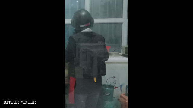 Une serveuse de café portant un gilet pare-balles et un casque au travail.